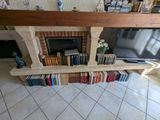a fireplace with a bunch of books on top of it