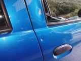 a blue car that has a broken door handle on it