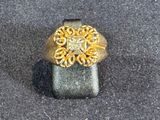 a gold and silver ring with a diamond on it