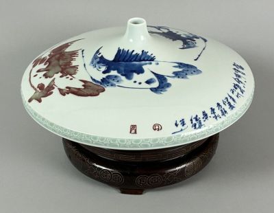 a blue and white plate with a fish on it