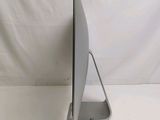 a computer monitor sitting on a stand on a white surface