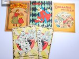 quatre livres pour enfants sont alignés sur une surface blanche