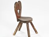 an old wooden chair with a heart shaped seat and legs