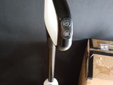 a black and white blender sitting on a table next to a box
