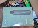 someone is holding a box with a speaker inside of it