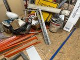 a pile of assorted items on the floor of a garage