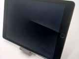 a tablet that is sitting on a stand on a table