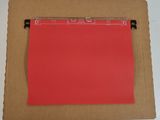 a red piece of paper on top of a brown piece of paper