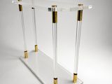 a clear and gold console table with two gold legs