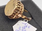 an image of a gold ring with a tag attached to it