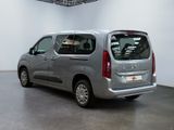 the silver van is parked in the large room of the building