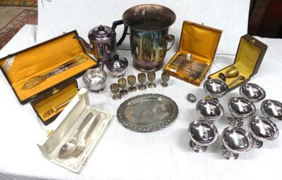 a lot of silver items on a table with a white table cloth
