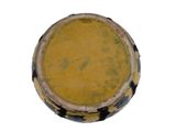 a yellow and black bowl sitting on a white surface