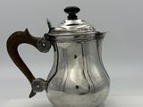 silver plated coffee pot with wooden handle and handle