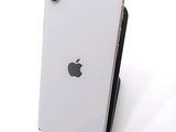 a white iphone sitting on top of a black stand