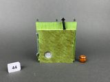 a small green building with a number on it