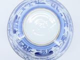 a blue and white bowl with a gold rim