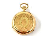 an image of a gold pocket watch sitting on a white surface