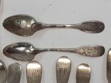 a lot of spoons and spoon spoons sitting on a table