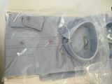 a blue shirt wrapped in plastic on a table