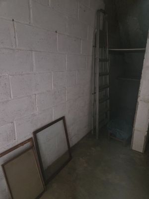 two empty picture frames sitting on the floor in a room