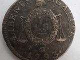 une vieille pièce de monnaie sur laquelle figure l'image d'un homme