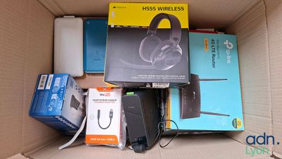 a cardboard box filled with electronics and other items