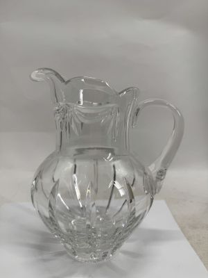 a glass pitcher sitting on top of a table