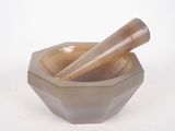 a bowl with a mortar and a pestor in it