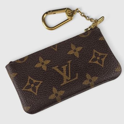 a close up of a brown louis vuitton keychain on a white background