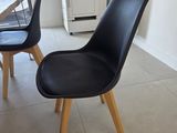 a black chair and a wooden table in a room