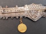 un gros plan d'un objet métallique sur lequel est posée une médaille d'or
