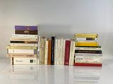 many books stacked on top of each other on a table