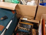 boxes of assorted items are stacked on a table in a room