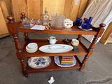 a wooden shelf with plates and bowls on it