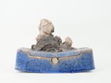 a small blue box with a rock in it