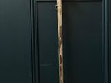 a cane that is leaning up against a wall