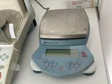 a scale on a table with a box of pills