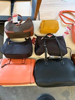 a lot of purses that are on a table