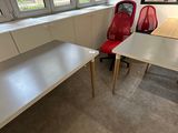 two red chairs and a white desk in an office