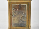 a gold clock sitting on top of a white table