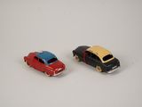 two toy cars sitting next to each other on a table
