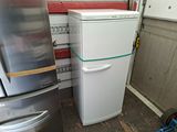 a refrigerator and a refrigerator freezer in a garage