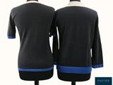 two women ' s black and blue sweaters on a mannequin mannequin
