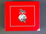 an image of a red box with a silver ornament on it