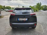 the rear end of a black suv parked in a parking lot