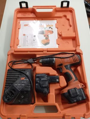 an orange case with a drill and two batteries in it