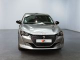 the front of a silver car is parked in a white room