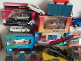 a lot of toy cars and trucks sitting on a table