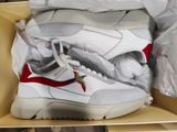 a box with a pair of white sneakers in it